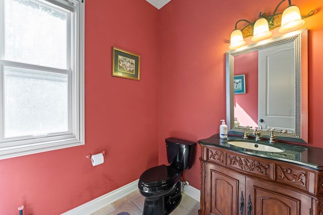 bathroom featuring vanity, tile patterned floors, and toilet