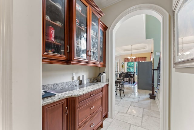 8557 Forestview Dr, Canton, MI 48187 - bar with arched walkways, stone tile flooring, stairs, freestanding refrigerator, and a chandelier