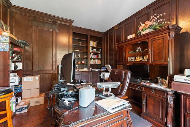 office featuring built in shelves, built in desk, and dark wood-type flooring