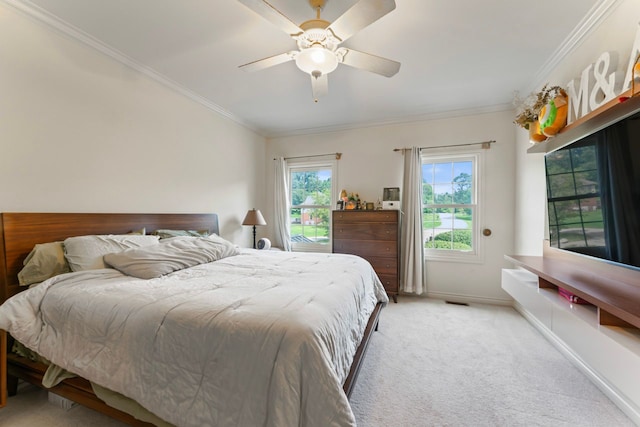 carpeted bedroom with crown molding and ceiling fan