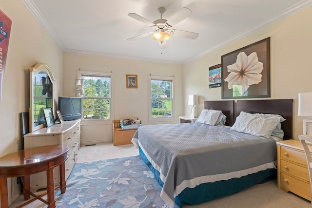 bedroom featuring ceiling fan, ornamental molding, and light carpet