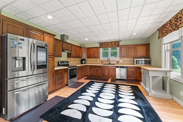 8557 Forestview Dr, Canton, MI 48187 - kitchen with appliances with stainless steel finishes, a sink, light wood finished floors, healthy amount of natural light, and recessed lighting