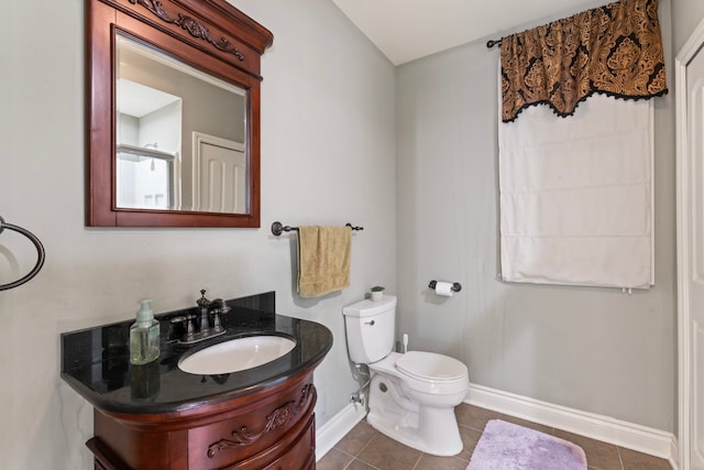 bathroom with tile patterned flooring, vanity, and toilet