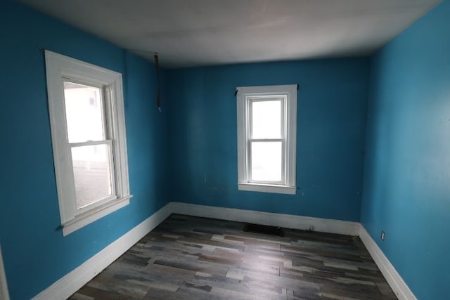 unfurnished room featuring dark wood-type flooring