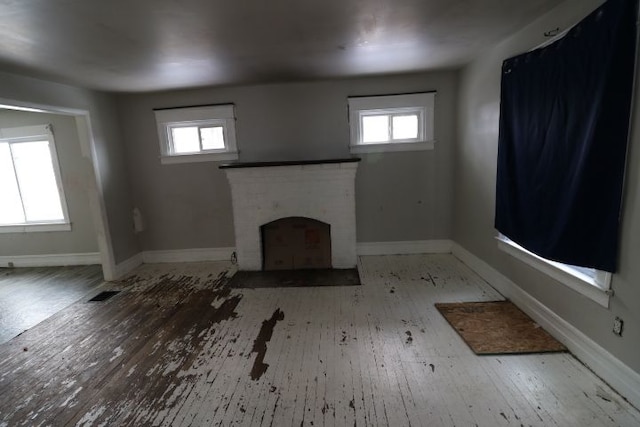 unfurnished living room with a fireplace and light hardwood / wood-style flooring