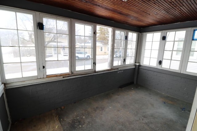 unfurnished sunroom featuring wooden ceiling