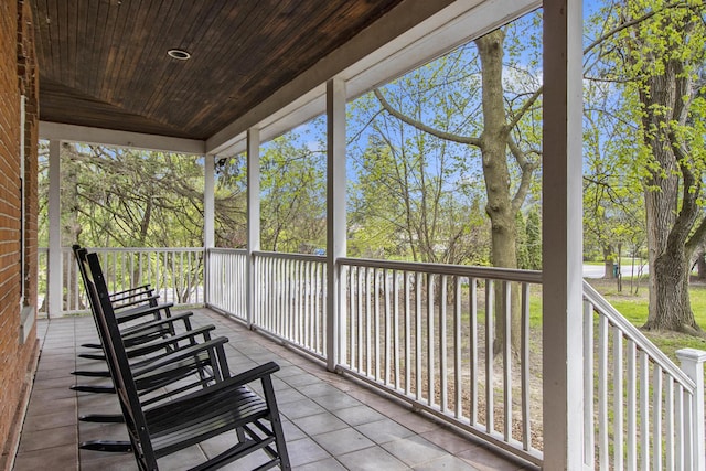 unfurnished sunroom with wooden ceiling