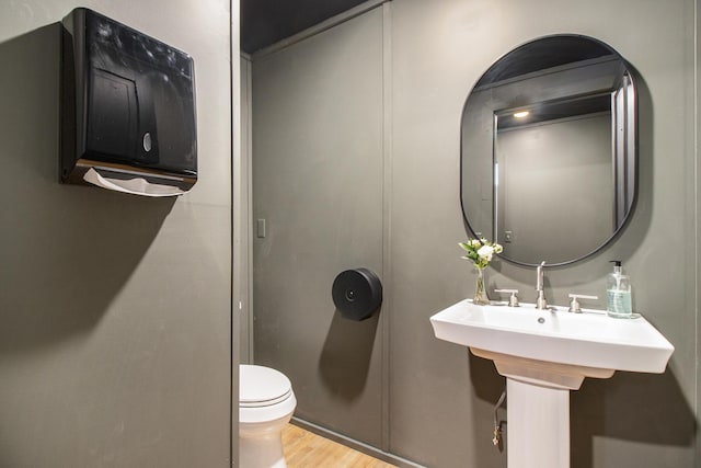 bathroom featuring toilet and hardwood / wood-style floors