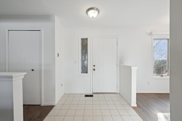 foyer featuring light tile patterned floors