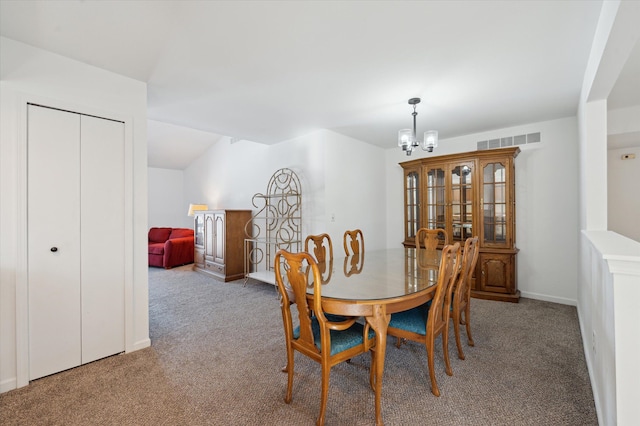 dining area featuring an inviting chandelier and carpet flooring