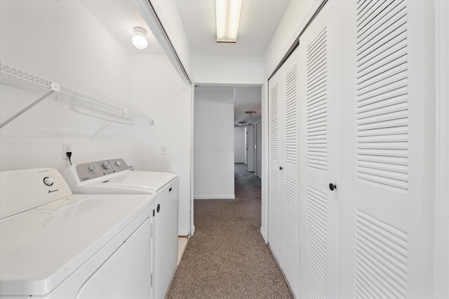 clothes washing area with light carpet and washer and clothes dryer