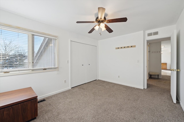 unfurnished bedroom with light carpet, ceiling fan, and a closet