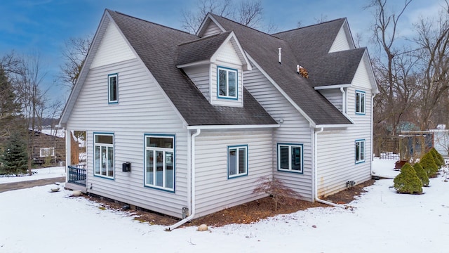 view of snow covered rear of property