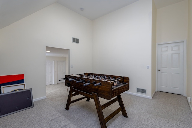 recreation room featuring high vaulted ceiling and light carpet