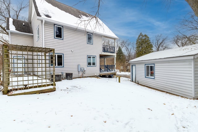 snow covered property featuring a balcony and a pergola