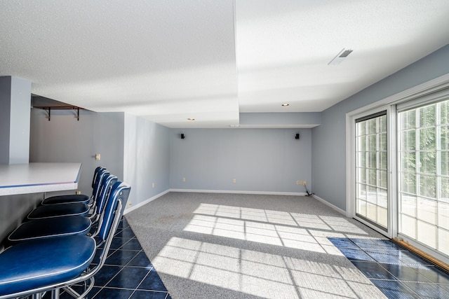 interior space with tile patterned flooring and a textured ceiling