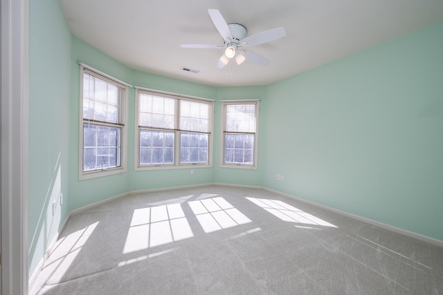 carpeted empty room featuring ceiling fan