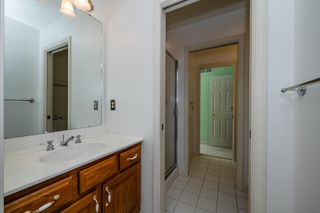 bathroom featuring vanity, tile patterned floors, and walk in shower