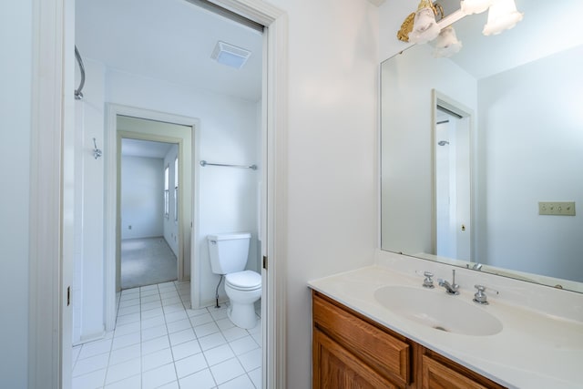 bathroom with vanity, tile patterned floors, and toilet