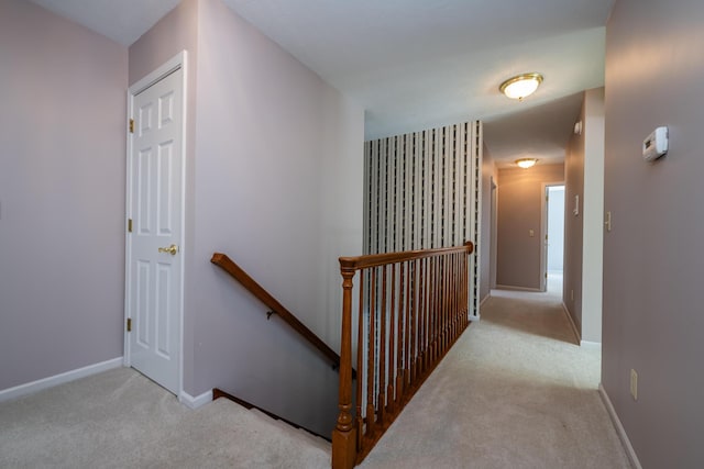 hall with light colored carpet