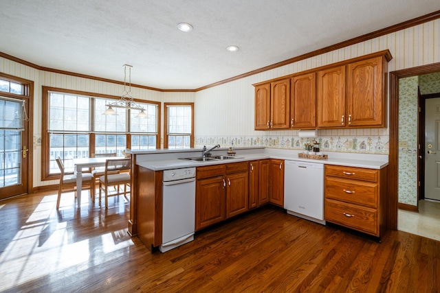 kitchen featuring dark hardwood / wood-style floors, decorative light fixtures, dishwasher, sink, and kitchen peninsula