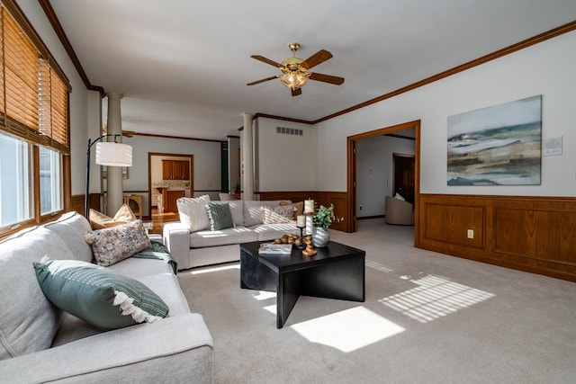 carpeted living room featuring crown molding and ceiling fan