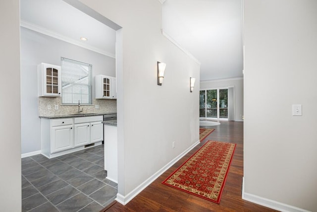 hallway featuring ornamental molding, sink, and dark hardwood / wood-style floors