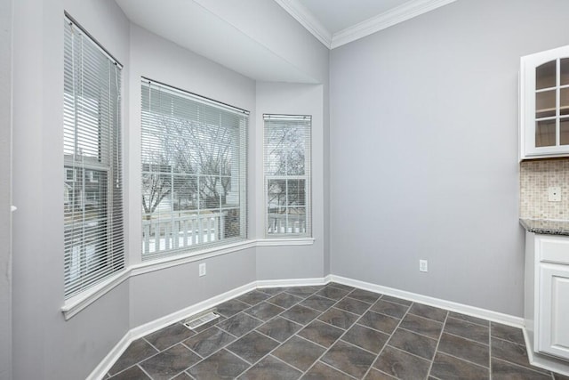 unfurnished dining area with ornamental molding