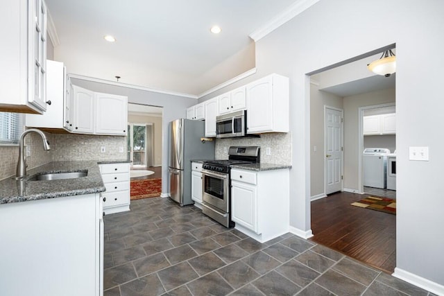 kitchen featuring dark stone countertops, white cabinets, and appliances with stainless steel finishes