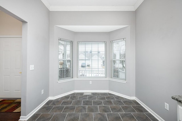 empty room featuring crown molding and plenty of natural light