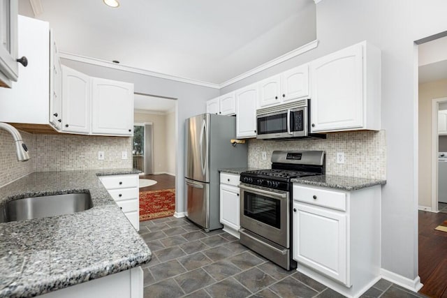 kitchen featuring white cabinetry, sink, light stone countertops, and appliances with stainless steel finishes