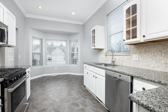 kitchen with white cabinetry, sink, stainless steel appliances, and light stone countertops