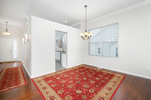 dining space featuring crown molding, sink, and dark wood-type flooring