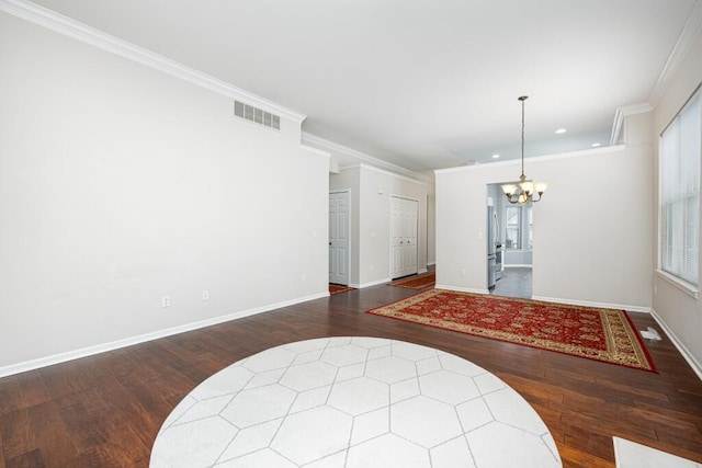 interior space featuring crown molding, dark wood-type flooring, and a notable chandelier