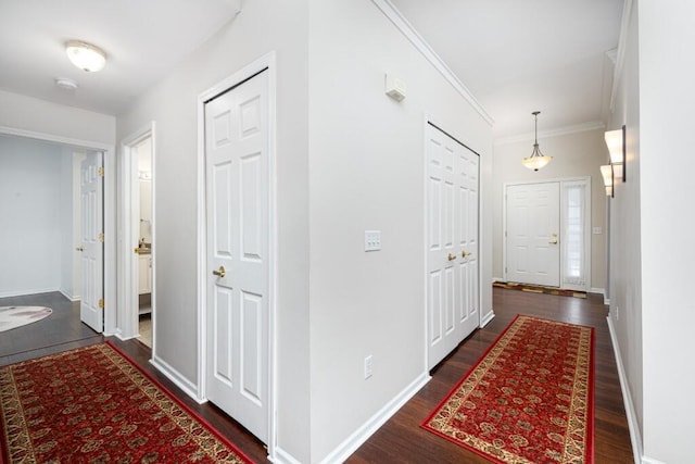 corridor featuring ornamental molding and dark hardwood / wood-style floors