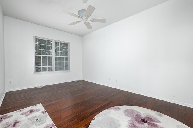 empty room featuring dark wood-type flooring and ceiling fan