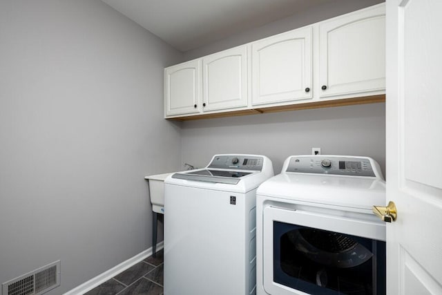 laundry room featuring cabinets and independent washer and dryer