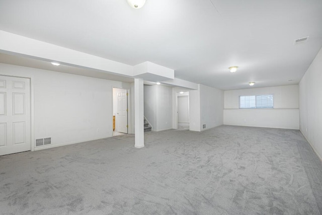 basement featuring light colored carpet