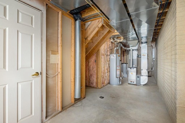 utility room featuring heating unit and gas water heater