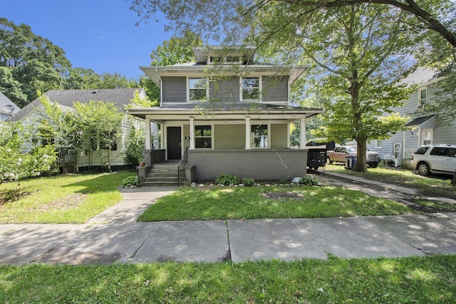 front facade with covered porch and a front lawn