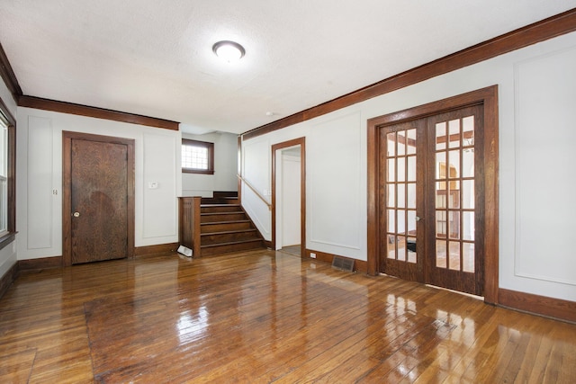 entryway featuring dark hardwood / wood-style flooring and french doors