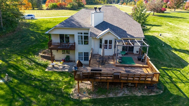 back of house with a wooden deck, a yard, and a patio area