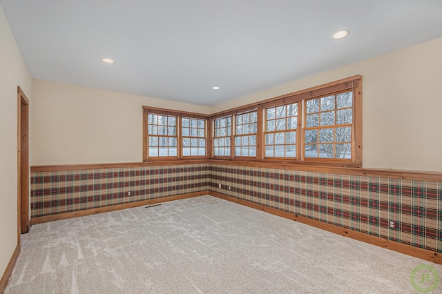 unfurnished room featuring light colored carpet