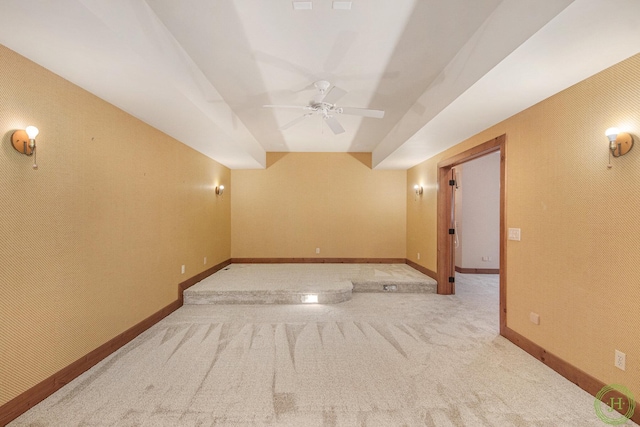 empty room featuring light colored carpet and ceiling fan