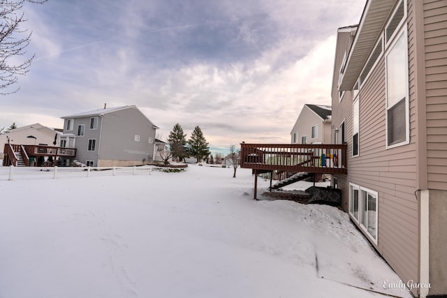 snowy yard with a wooden deck