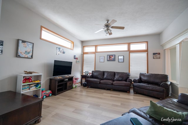 living room with light hardwood / wood-style flooring and ceiling fan