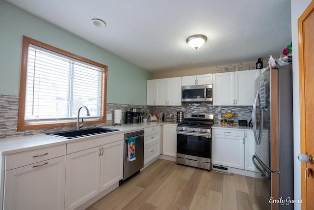 kitchen with appliances with stainless steel finishes and white cabinets