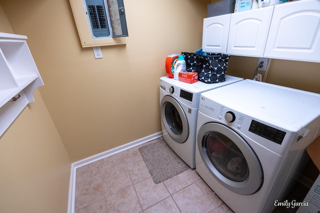 laundry area featuring cabinets, washing machine and clothes dryer, electric panel, and light tile patterned floors