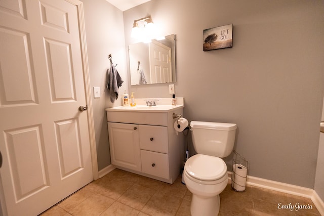 bathroom with vanity, tile patterned flooring, and toilet