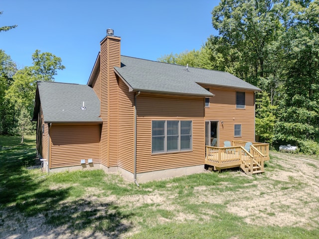 rear view of house featuring a deck